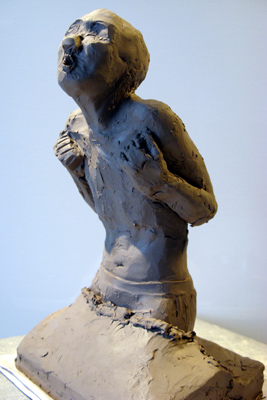 Clay model of man in sea reacting to the cold/