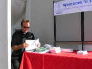 The Vicar looking at leaflets at the welcome desk.